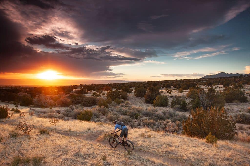 man riding bike on new mexico landscape